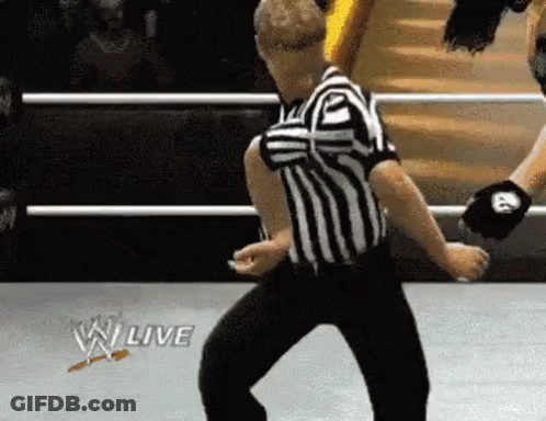 Referee Dancing In Wrestling Ring With W Live Logo GIF