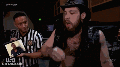 Referee Displays Photo To Second Wrestler GIF