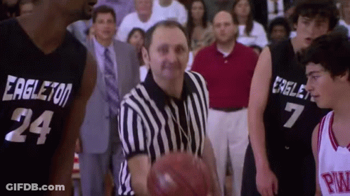 Referee Holding Basketball In Front Of Two Players GIF