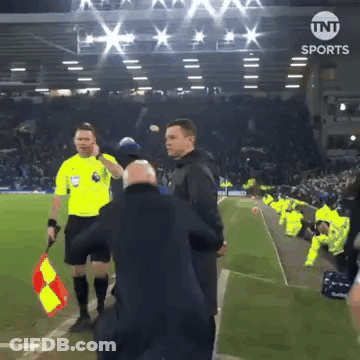 Referee Holding Red And Yellow Flag At TNT Sports Sign GIF