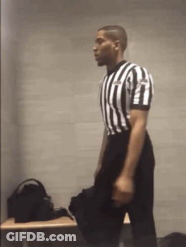Referee In Black And White Striped Shirt Kneeling GIF