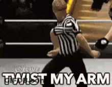 Referee In Wrestling Ring Saying Twist My Arm GIF
