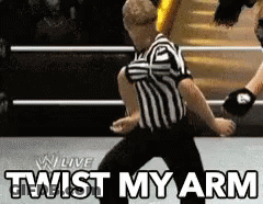 Referee In Wrestling Ring Saying Twist My Arm GIF