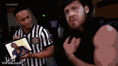 Referee Showing Wrestler Picture To Wrestler GIF