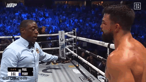 Referee Talking To Boxer In Ring GIF