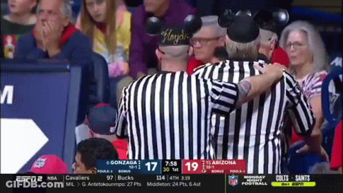 Referee With Mickey Mouse Ears Talks To Another Referee GIF