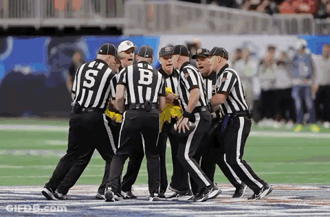 Referees Standing On Football Field GIF