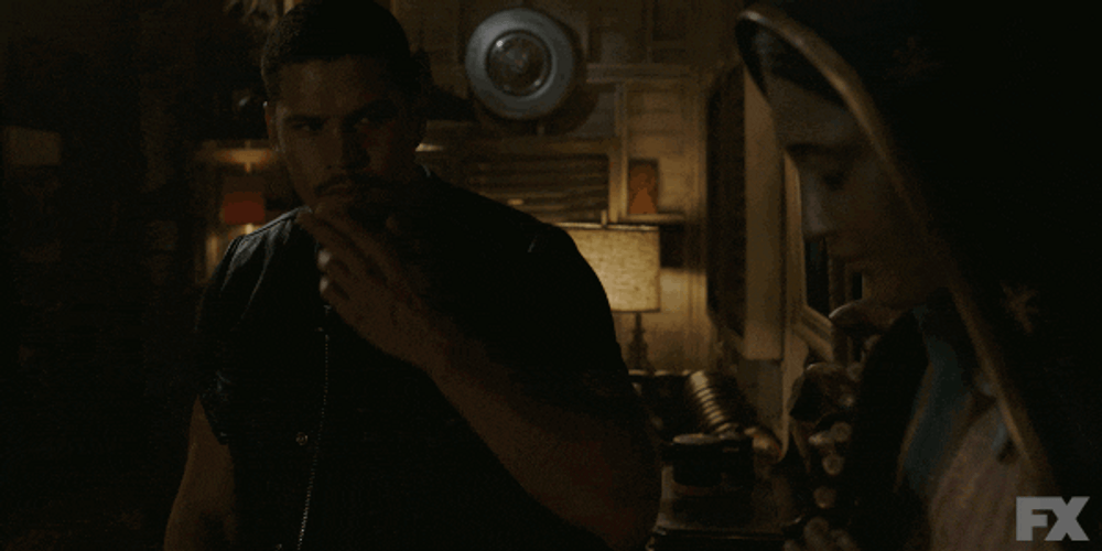 Religious Man Kissing His Fingers GIF
