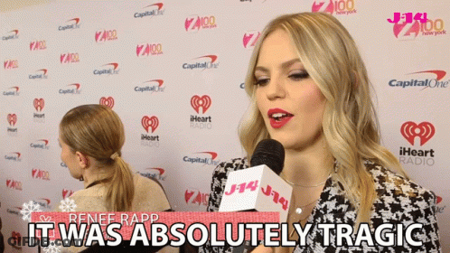 Renee Rapp Says It Was Absolutely Tragic In Front Of A Wall Of Iheart Radio Logos GIF