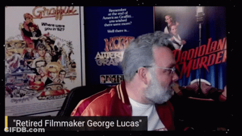 Retired Filmmaker George Lucas In Front Of Movie Poster GIF