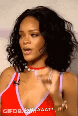 Rihanna In Red Tank Top Talking On Microphone GIF