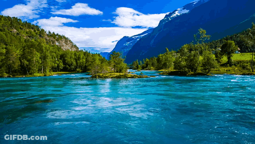 River Flowing Through Mountains With Trees GIF