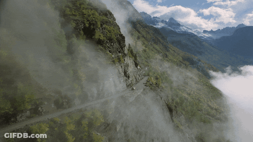 Road Up Mountain Covered In Clouds GIF