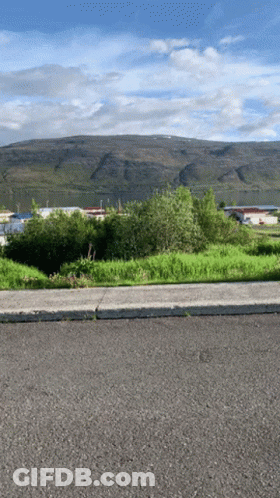 Road With Mountain And Buildings GIF