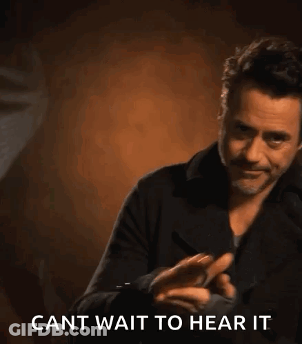 Robert Downey Jr. Holding Cell Phone Saying Cant Wait To Hear It GIF