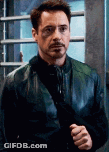 Robert Downey Jr. Holding Gun In Black Leather Jacket GIF