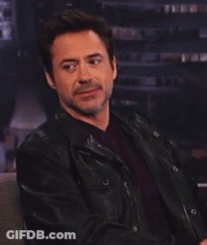 Robert Downey Jr. Is Wearing A Black Leather Jacket And A Red Shirt GIF