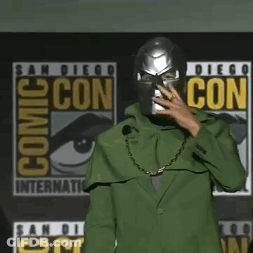 Robert Downey Jr. Is Wearing A Green Cape And A Chain Around His Neck . GIF
