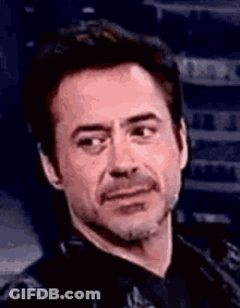Robert Downey Jr. Making Funny Face In Black Shirt And Tie GIF