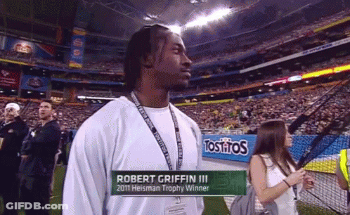 Robert Griffin III 2011 Heisman Winner In Front Of Tostitos Sign GIF