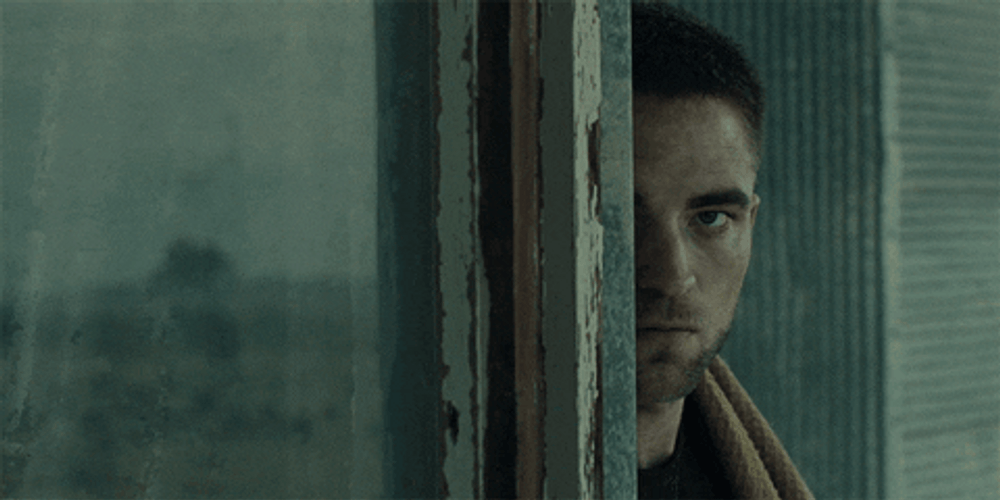 Robert Pattinson Peeking Behind Wall GIF