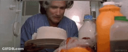 Robin Williams Is Looking At A Cake In The Refrigerator . GIF