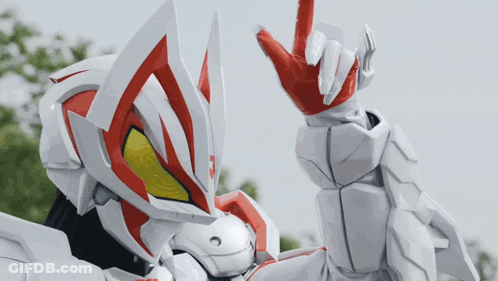 Robot In Red And White Helmet Making Peace Sign GIF