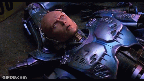 Robot Laying On Ground With Yellow Box GIF