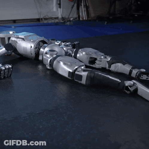 Robot Lying On Black Mat GIF