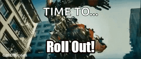 Robot Says Time To Roll Out In Front Of Building GIF