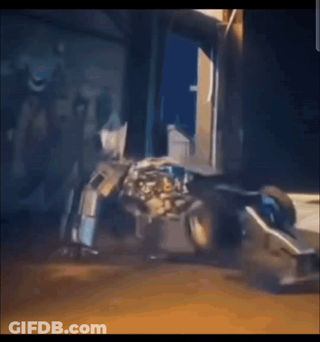 Robot Sitting In Front Of Building In Video Game GIF