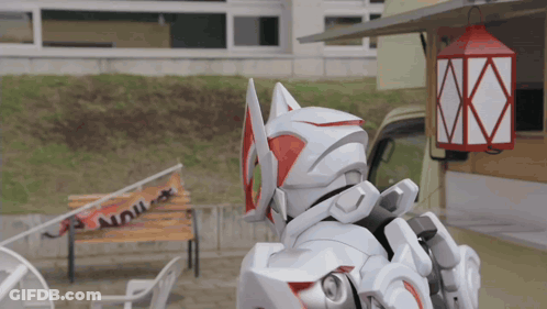 Robot Standing Before Building With Red Lantern GIF