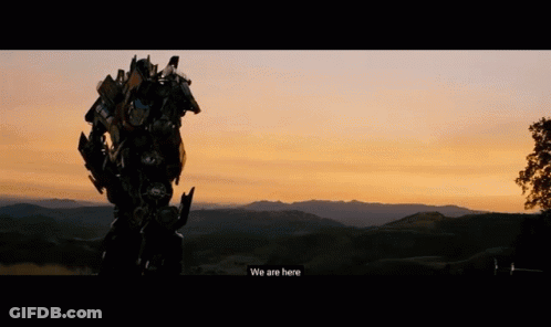 Robot Standing In Field At Sunset GIF