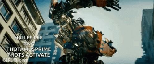 Robot Standing In Front Of Building Saying Hailes Lee Aka Thotamusprime Thots Activate GIF