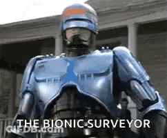 Robot Standing In Front Of Building Saying The Bionic Surveyor GIF