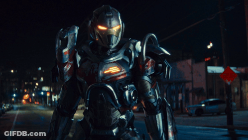 Robot Standing In Front Of Red And White Stop Sign GIF
