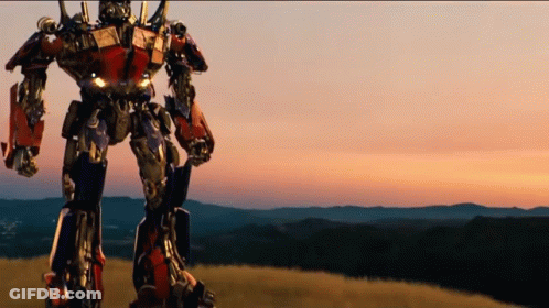 Robot Standing On Grassy Hill GIF