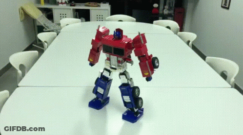 Robot Standing On Table In Room GIF