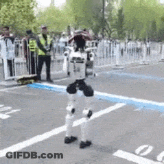 Robot Walking In Parking Lot As People Watch GIF
