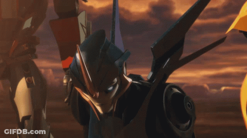 Robot With Blue Eyes In Front Of Yellow Robot GIF