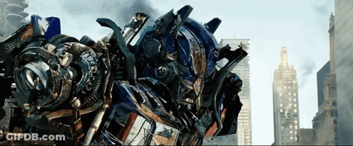 Robot With Helmet In Front Of City Skyline GIF