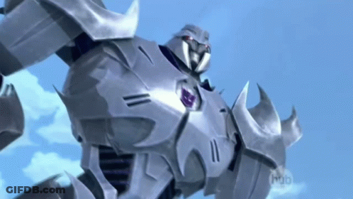Robot With Red Head Standing In Front Of Shipping Containers GIF