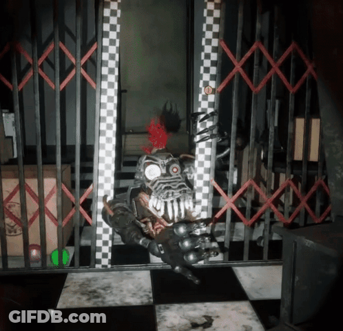 Robot With Red Mohawk Behind Bars GIF