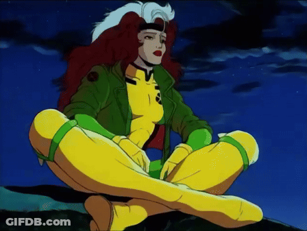 Rogue From The X-Men Sits On A Rock With Her Legs Crossed GIF