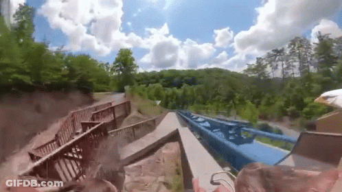 Roller Coaster Going Down Hill With Bridge GIF