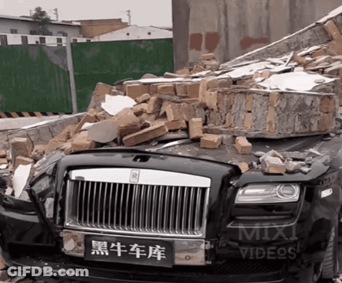 Rolls Royce In Pile Of Bricks Next To Mix Videos Sign GIF