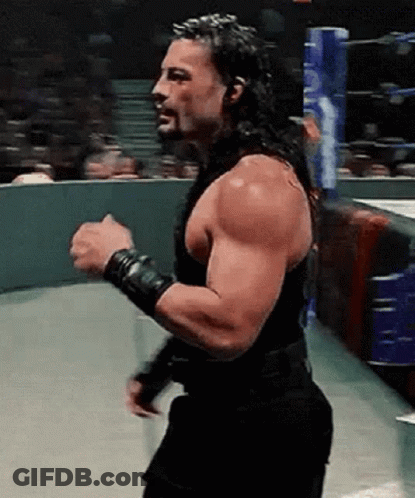 Roman Reigns Is A Wrestler With A Beard And Long Hair . GIF