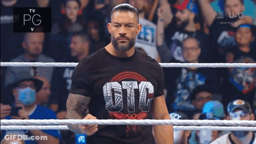 Roman Reigns Is Standing In A Wrestling Ring Wearing A Gfc Shirt GIF