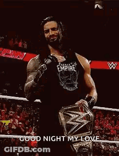 Roman Reigns Is Wearing A Black Tank Top And Holding A Wrestling Championship Belt . GIF
