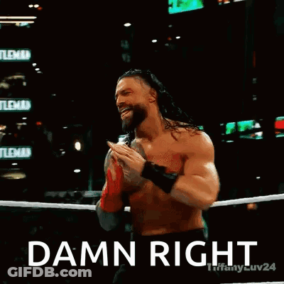 Roman Reigns Is Wearing Red Boxing Gloves And Pointing At The Camera In A Wrestling Ring . GIF